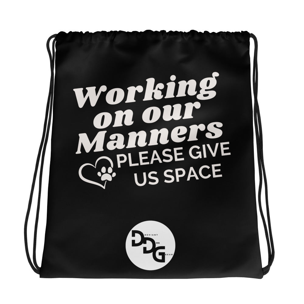 Working on Our Manners Drawstring bag